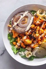 Harissa Roasted Cauliflower and Chickpeas with Tahini Sauce 