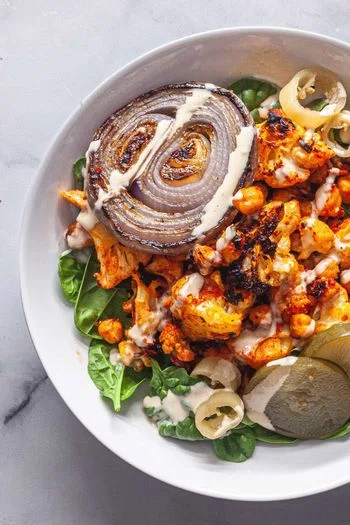 Harissa Roasted Cauliflower and Chickpeas with Tahini Sauce